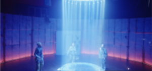 Three people stand around a circular platform lit by vertical beams of light. The curved wall behind them is lit dramatically to emphasise the industrial feel of the space.