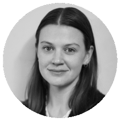 Black and white portrait of a young woman with straight, dark hair, wearing small hoop earrings and a light-colored top, looking directly at the camera with a neutral expression.